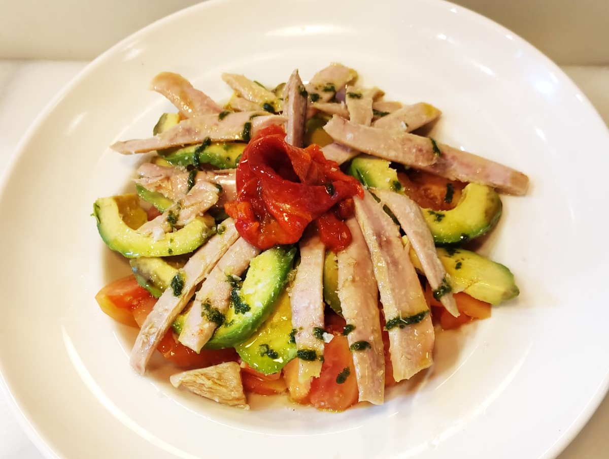 white tuna belly with tomatoes, avocado and roast pepper flower